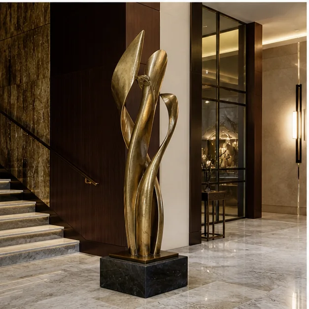 Brass sculpture integrated into a luxury interior with marble, wood, stone, glass, and refined lighting