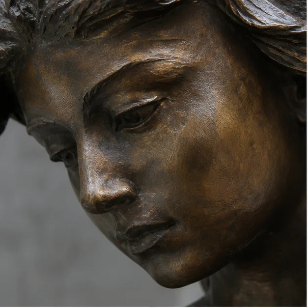 Close-up face detail from a bronze sculpture