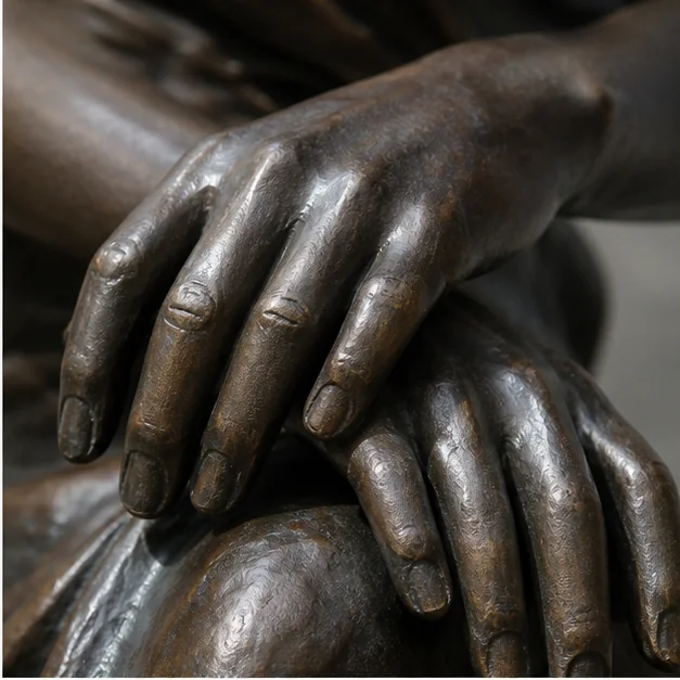 Bronze sculpture hands detail with patina and casting texture
