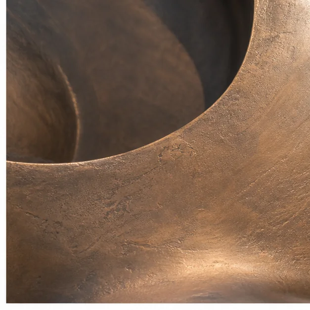 Close-up of a bronze sculpture showing natural patina and hand-finished detail