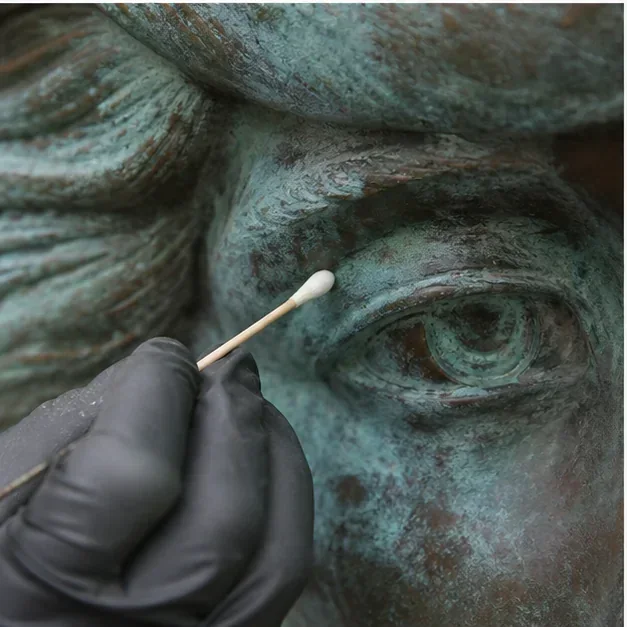 Patina maintenance detail on a bronze sculpture
