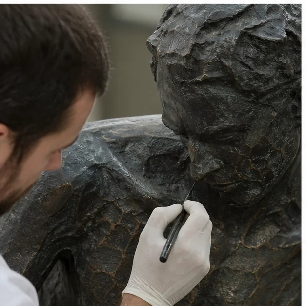 Careful restoration work being carried out on a damaged sculpture